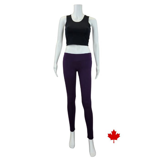 white mannequin wearing plum purple eve yoga full length leggings and black stephanie crop tank top front view on white background