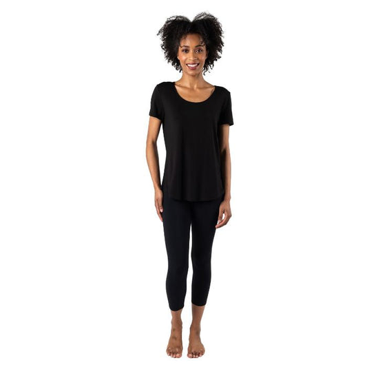 female model wearing black brenda u-necktee and black suri capri leggings front view on white background