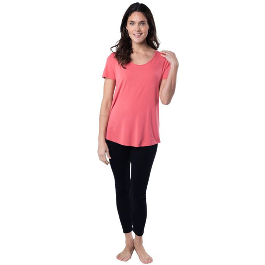 female model wearing coral pink brenda u-neck tee and black suri leggings front view on white background