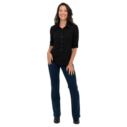 female model wearing indigo blue daya pants and black lorrine blouse front view on white background