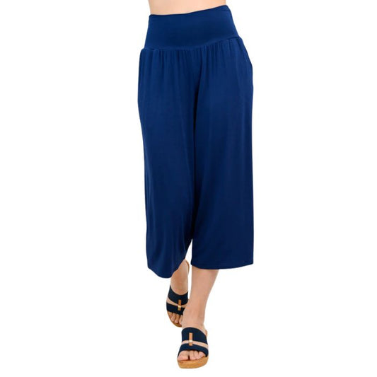 female model wearing indigo blue gaylene capri pants front view on white background