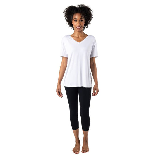 female model wearing white harper tee and black suri capri leggings front view on white background