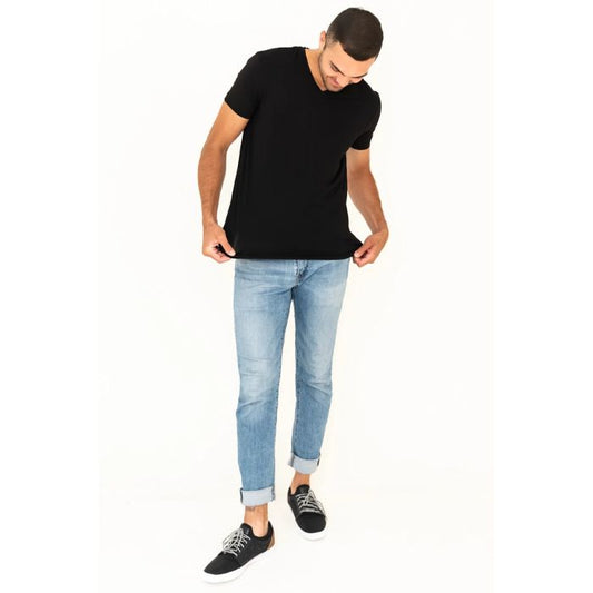 male model wearing black huron v-neck t-shirt back and blue jeans front view on white background
