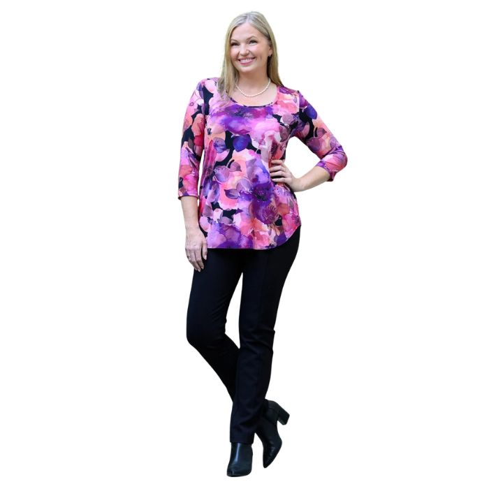 a women wearing royale garden print jazz top and black nadia pants front view on white background