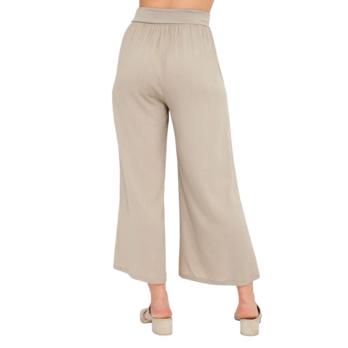 female model wearing sand brown landon capri pants back view on white background