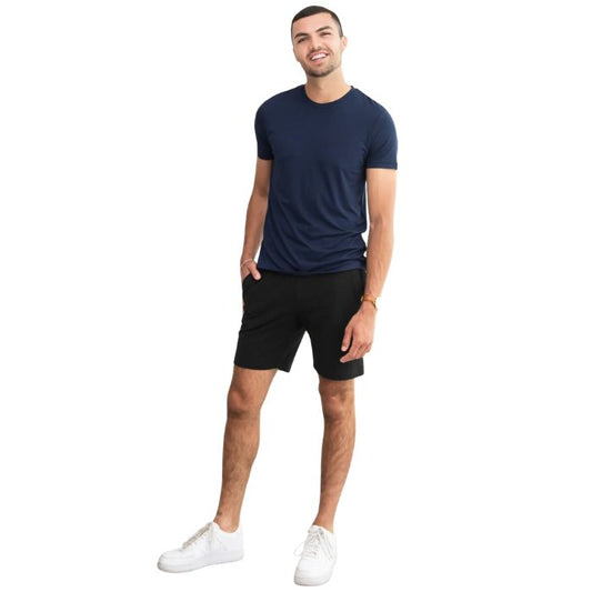 male model wearing ink blue lawrence crew neck t-shirt and black aspen shorts front view on white background