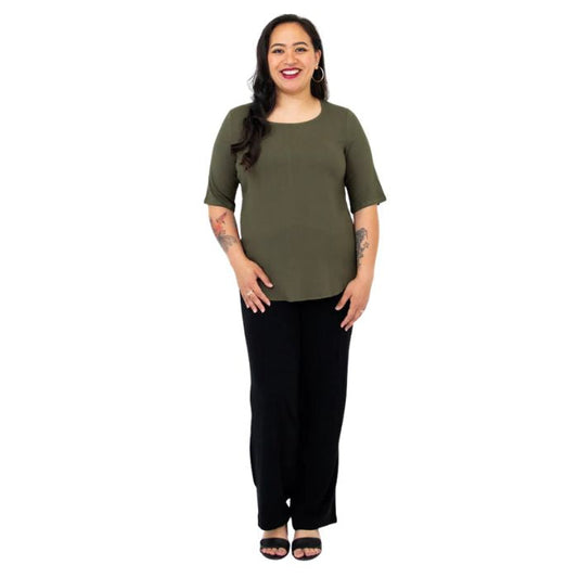 female model wearing khaki green liza top and black landon pants front view on white background