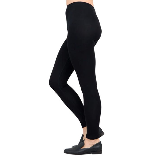 female model wearing black ruby leggings side view on white background