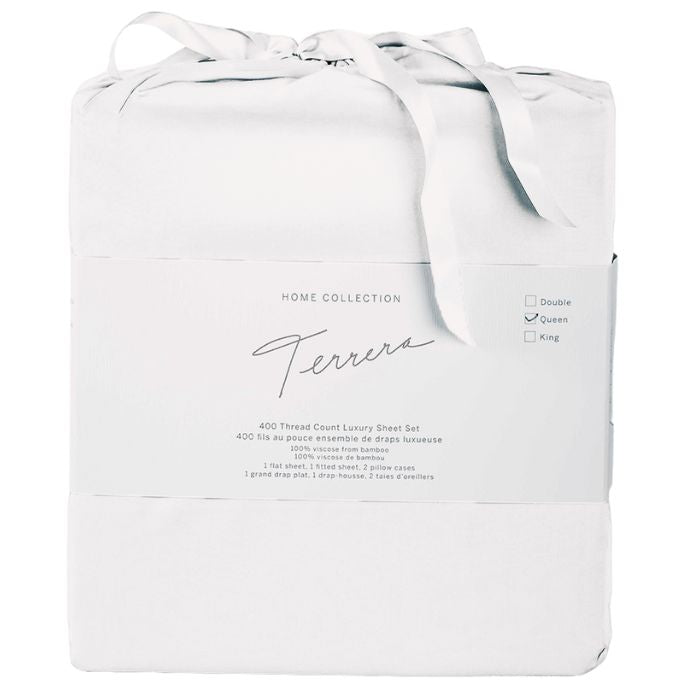 white bamboo fabric bag containg sheet set- flat sheet, fitted sheet and two pillowcases on white background