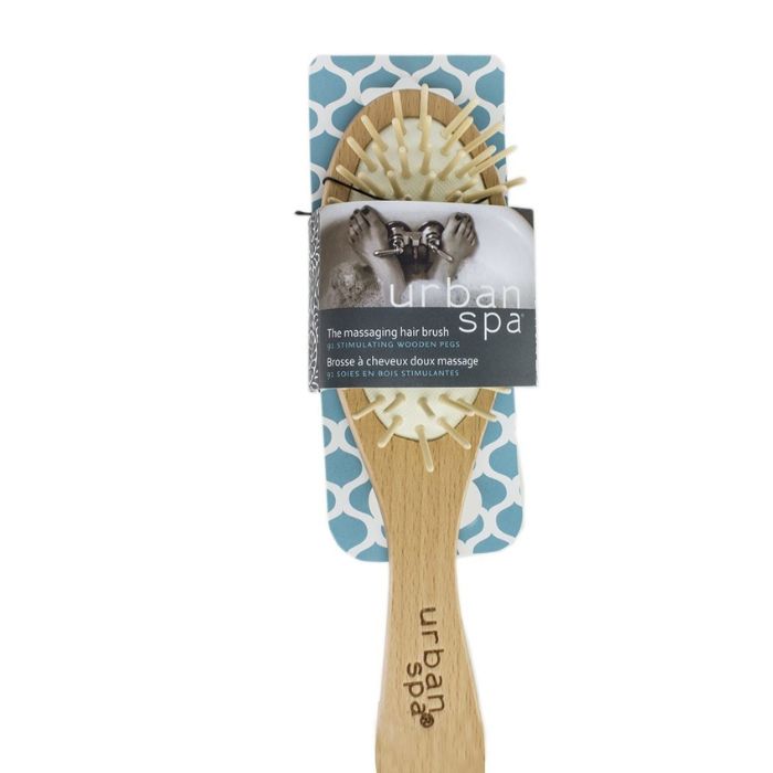 the massaging hair brush in package front view on white background