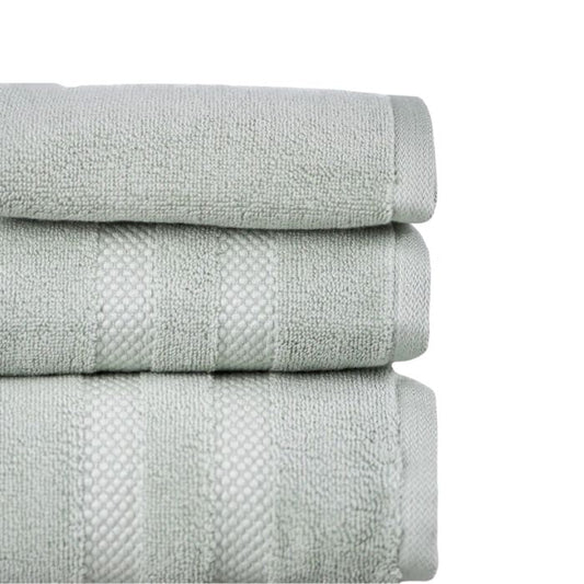 stacked desert sage green three piece towel set side view on white background