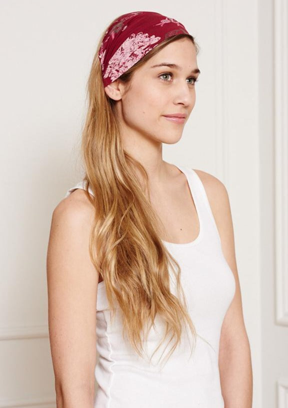 This Is J's Wide Headbands reverse from a unique print to a solid color. The fabric is ultra-soft and moisture-wicking and is soft enough to scrunch and fold into different widths. It comes twisted in the back for a comfortable tapered fit.  Made in Canada  Fabrication: 93% Viscose from Bamboo / 7% Spandex. $16.00 lovely flower burgundy red