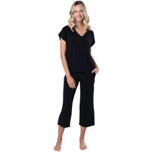 female model wearing black alicia v-neck top and black dion capri pants front view on white background