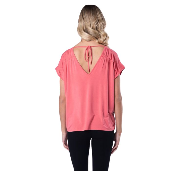 top of female model wearing coral pink alicia v-neck top back view on white background