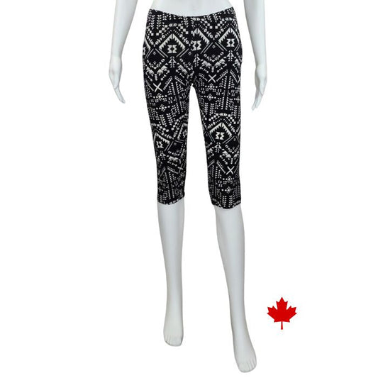 bottom of white mannequin wearing geometric print elle 3/4 length leggings front view on white background