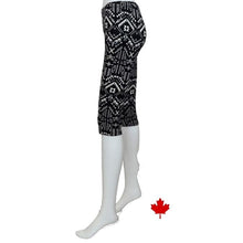 bottom of white mannequin wearing geometric print elle 3/4 length leggings side view on white background