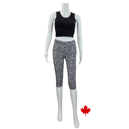 white mannequin wearing leopard print elle 3/4 length leggings and black stephanie crop tank top front view on white background