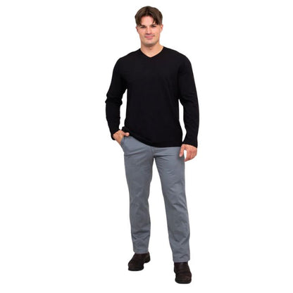 male model wearing black adam long sleeve shirt and grey pants front view on white background