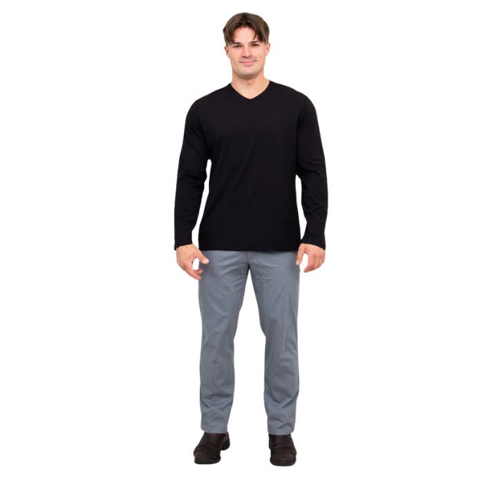 male model wearing black adam long sleeve shirt and grey pants front view on white background