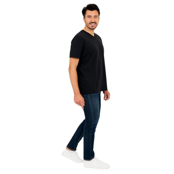 male model wearing black adam short sleeve shirt and blue jeans side view on white background