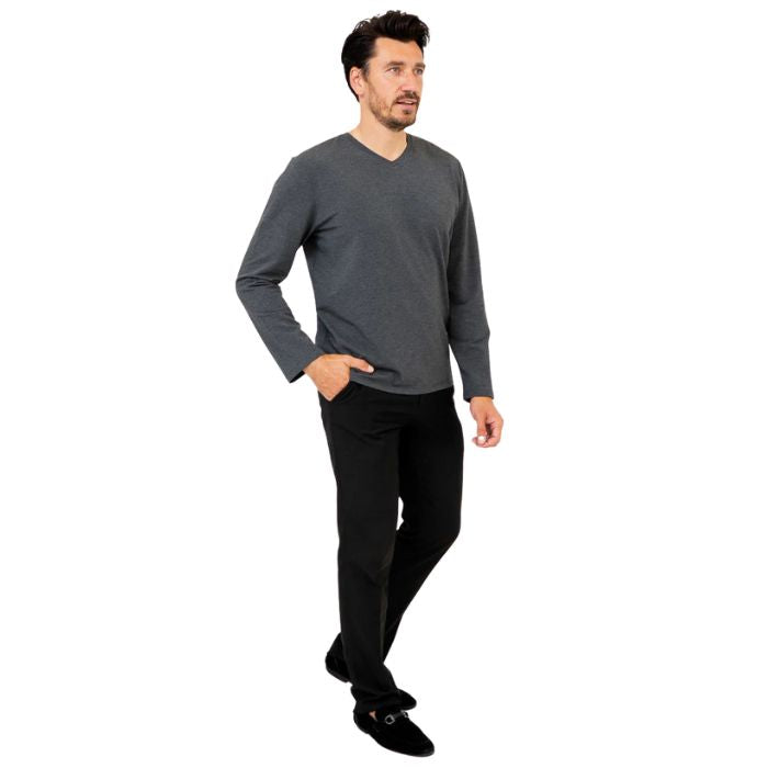 male model wearing graphite grey adam long sleeve shirt and black pants side view on white background