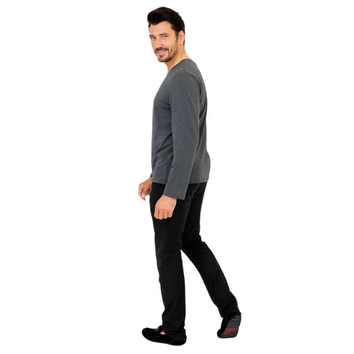 male model wearing graphite grey adam long sleeve shirt and black pants side view on white background