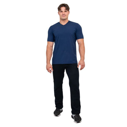 male model wearing indigo blue adam short sleeve shirt and black pants front view on white background