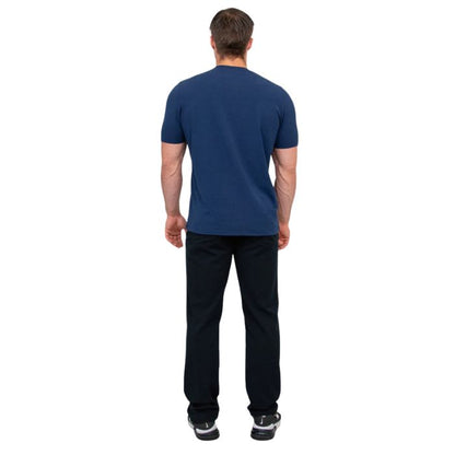 male model wearing indigo blue adam short sleeve shirt and black pants back view on white background