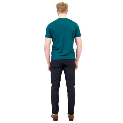 male model wearing teal green adam short sleeve shirt and black pants back view on white background