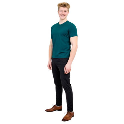 male model wearing teal green adam short sleeve shirt and black pants front view on white background