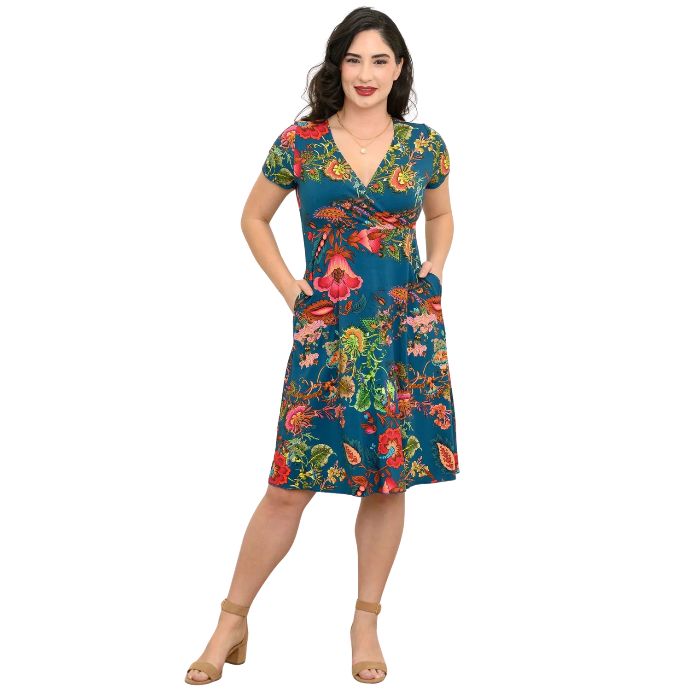 woman wearing teal fantasy print aurora dress front view set on a white background