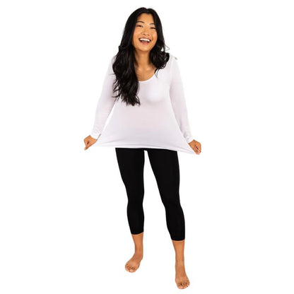 female model wearing white aurora long sleeve top and black suri capri leggings front view on white background