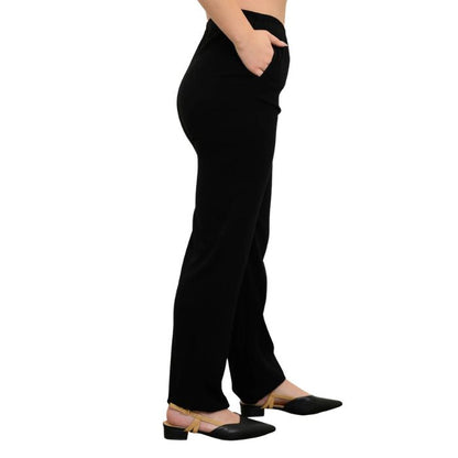 female model wearing black bella pants side view on white background