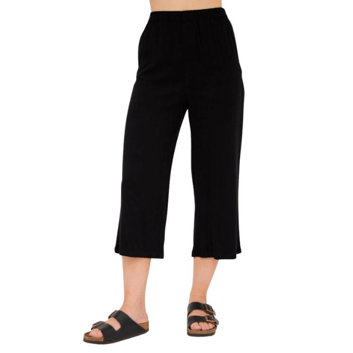 female model wearing black bella capri pants front view on white background