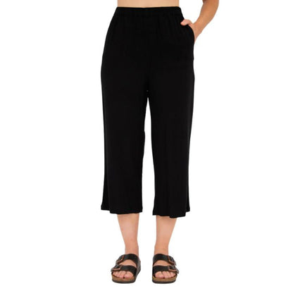 female model wearing black bella capri pants front view on white background