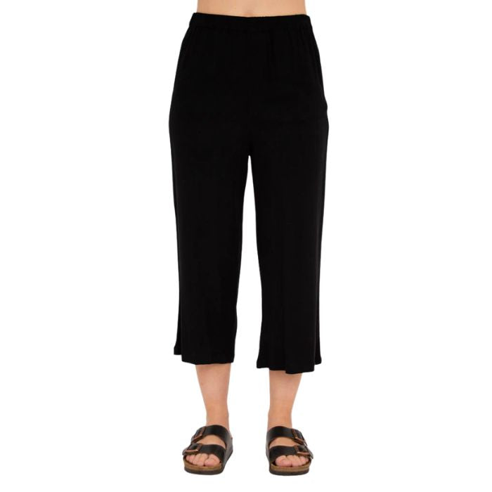 female model wearing black bella capri pants front view on white background