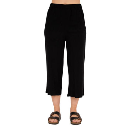 female model wearing black bella capri pants front view on white background