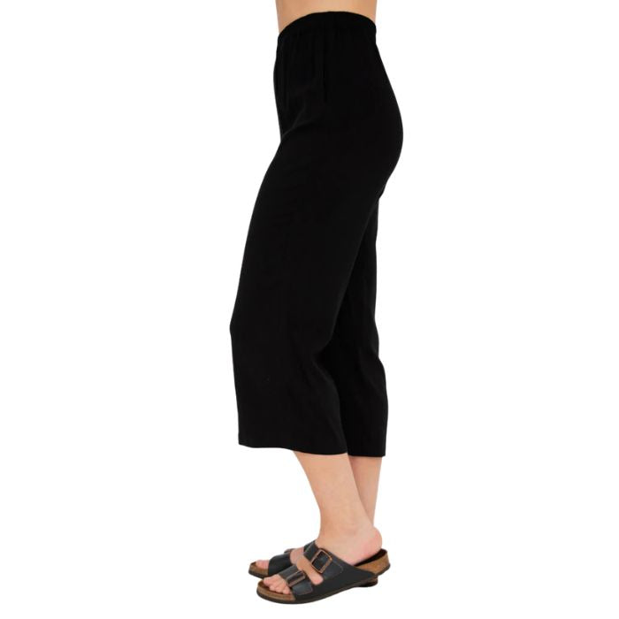 female model wearing black bella capri pants side view on white background