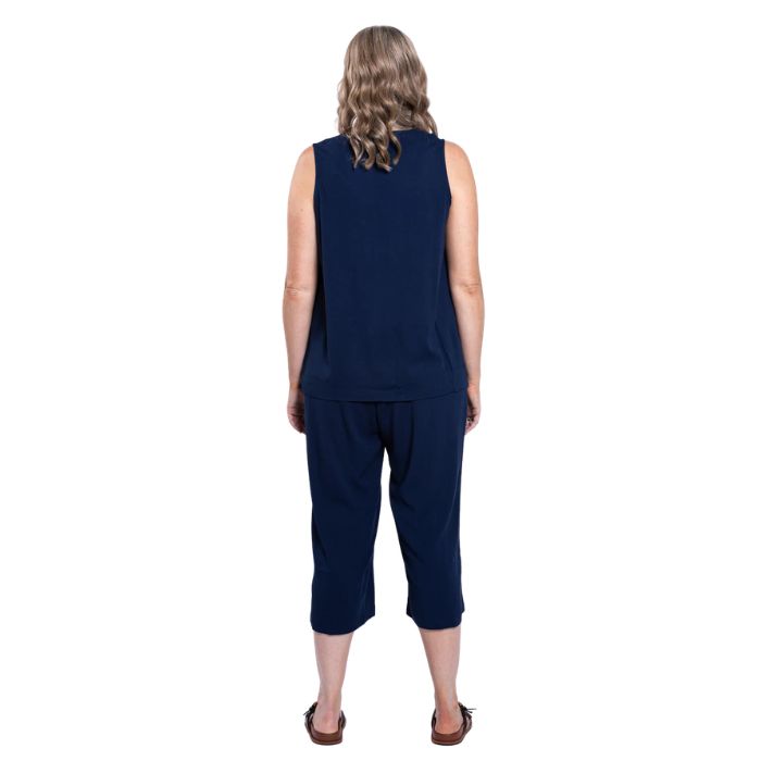 female model wearing indigo blue bella capri pants and indigo blue scarlette top back view on white background