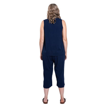 female model wearing indigo blue bella capri pants and indigo blue scarlette top back view on white background