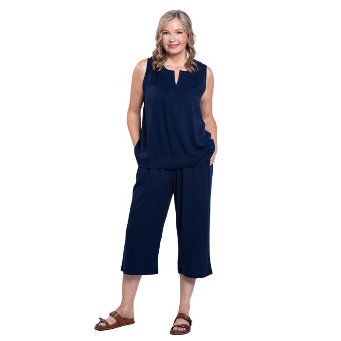 female model wearing indigo blue bella capri pants and indigo blue scarlette top front view on white background