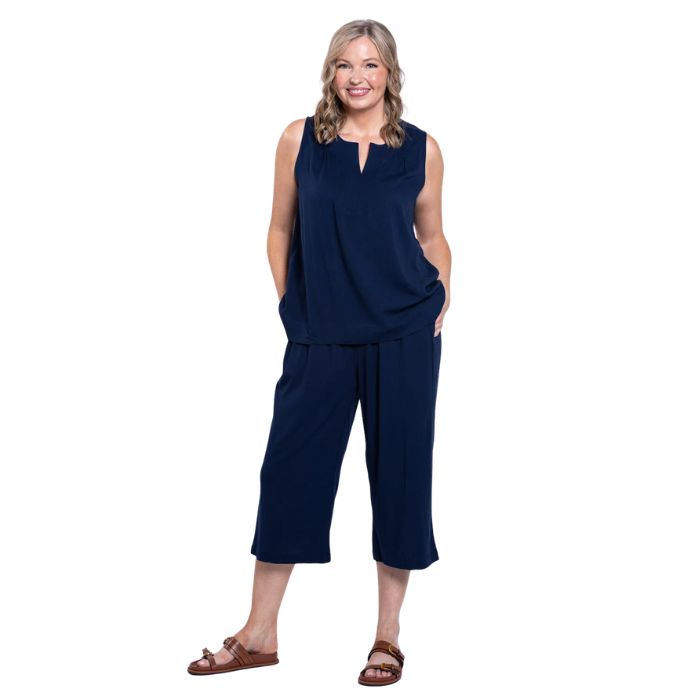 female model wearing indigo blue bella capri pants and indigo blue scarlette top front view on white background
