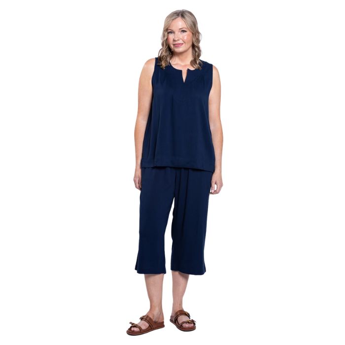 female model wearing indigo blue bella capri pants and indigo blue scarlette top front view on white background