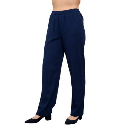 female model wearing indigo blue bella pants side view on white background