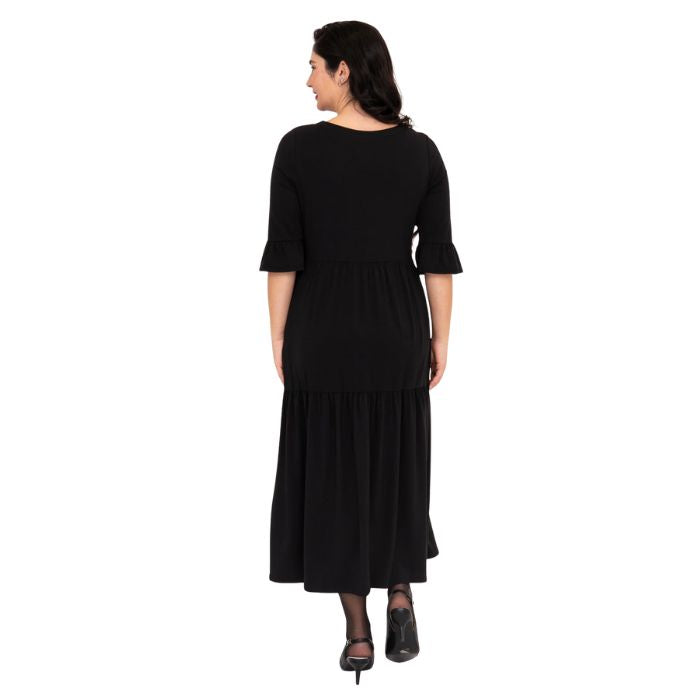 female model wearing black bernadette dress back view on white background