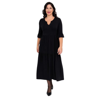 female model wearing black bernadette dress front view on white background