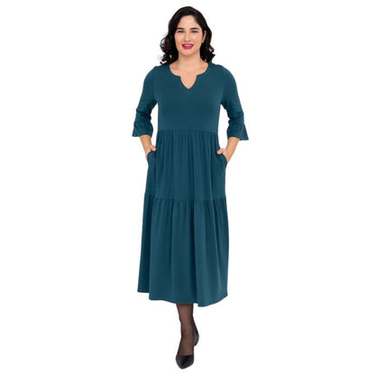 female model wearing teal green bernadette dress front view on white background