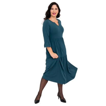 female model wearing teal green bernadette dress side view on white background