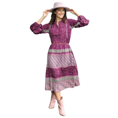 female model wearing blue bayou dress mixed prints front view on white background