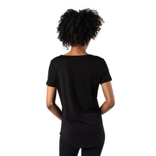 top of female model wearing black brenda u-neck tee back view on white bacground